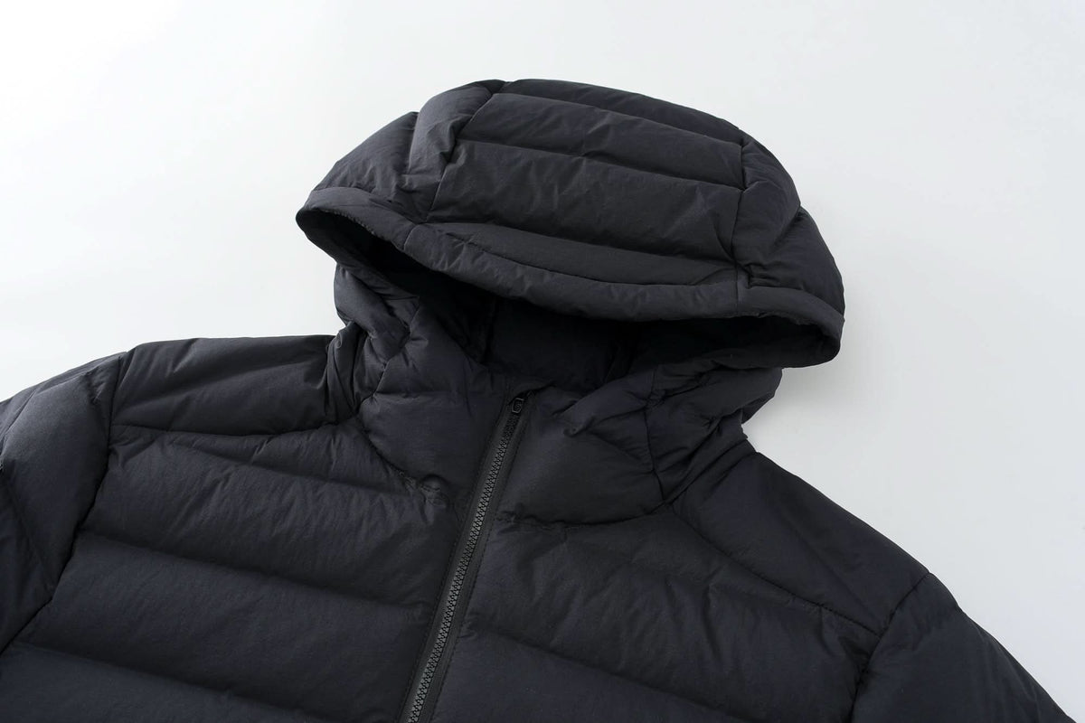 Black down jacket hood detail with full-zip and padded collar protection