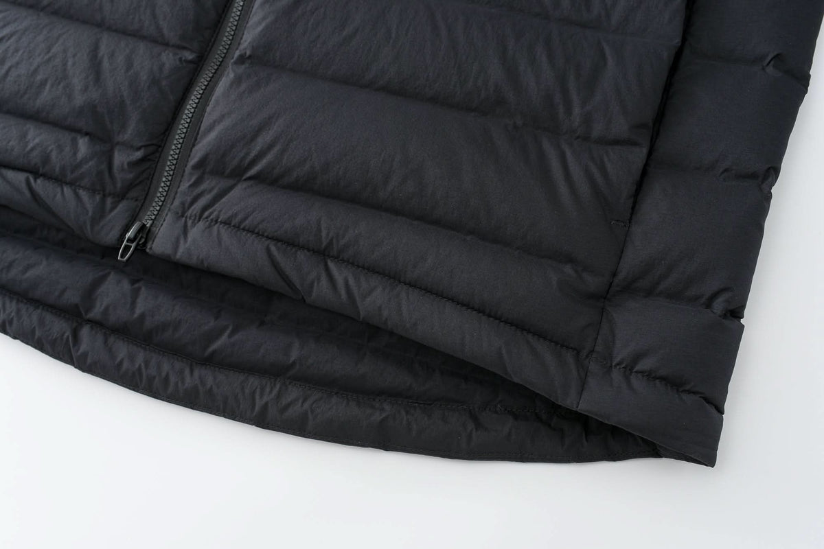 Black down jacket hem and horizontal quilting, side view