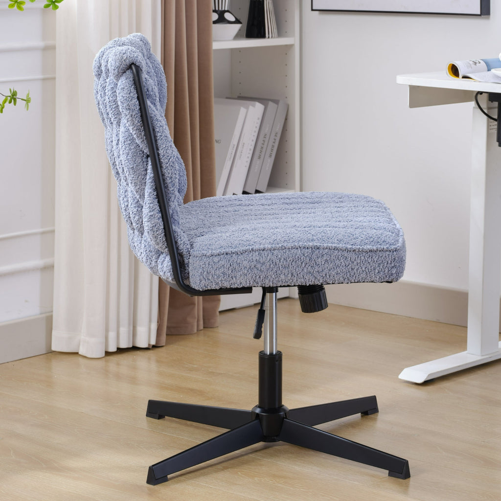 Blue armless desk chair with tufted fabric seat, curved backrest, and black star base.