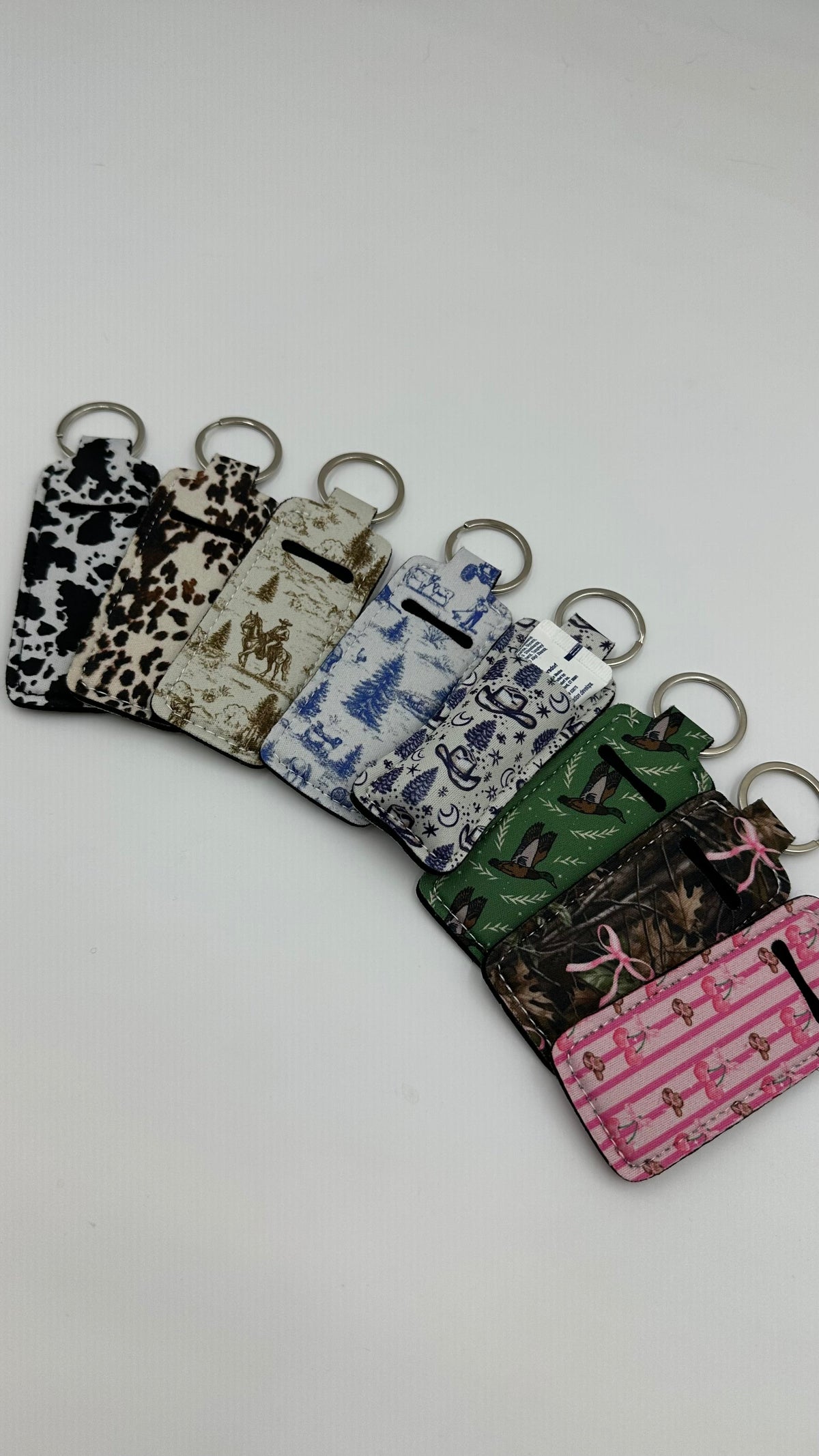 Chapstick holder keychain set with mixed Western prints and colorful accents, metal rings