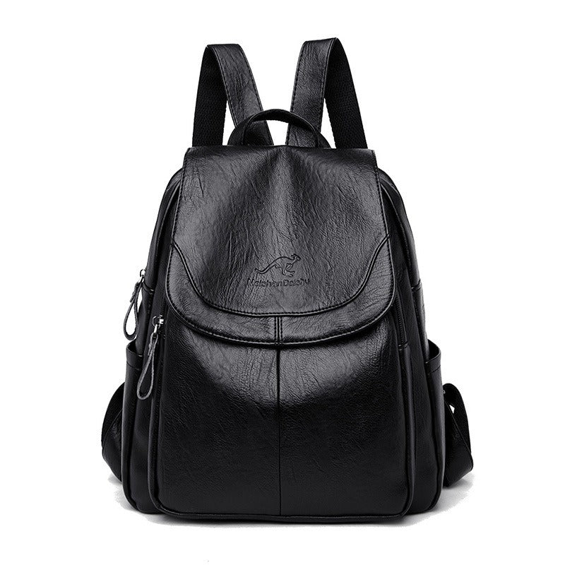 Women’s black mini backpack with front flap pocket, top handle, and side zipper details
