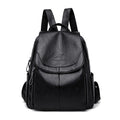 Women’s black mini backpack with front flap pocket, top handle, and side zipper details