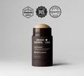 Deodorant stick in dark tube, label shows ORRIS & SANTAL scent