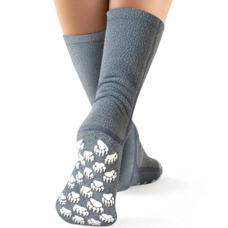 Soft grey fleece crew socks with white paw print grippers on sole