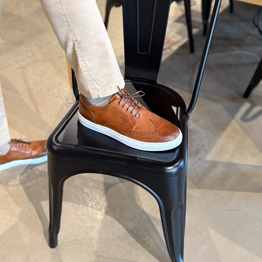Men's cognac wingtip lace-up dress shoes with white soles, toe and side view
