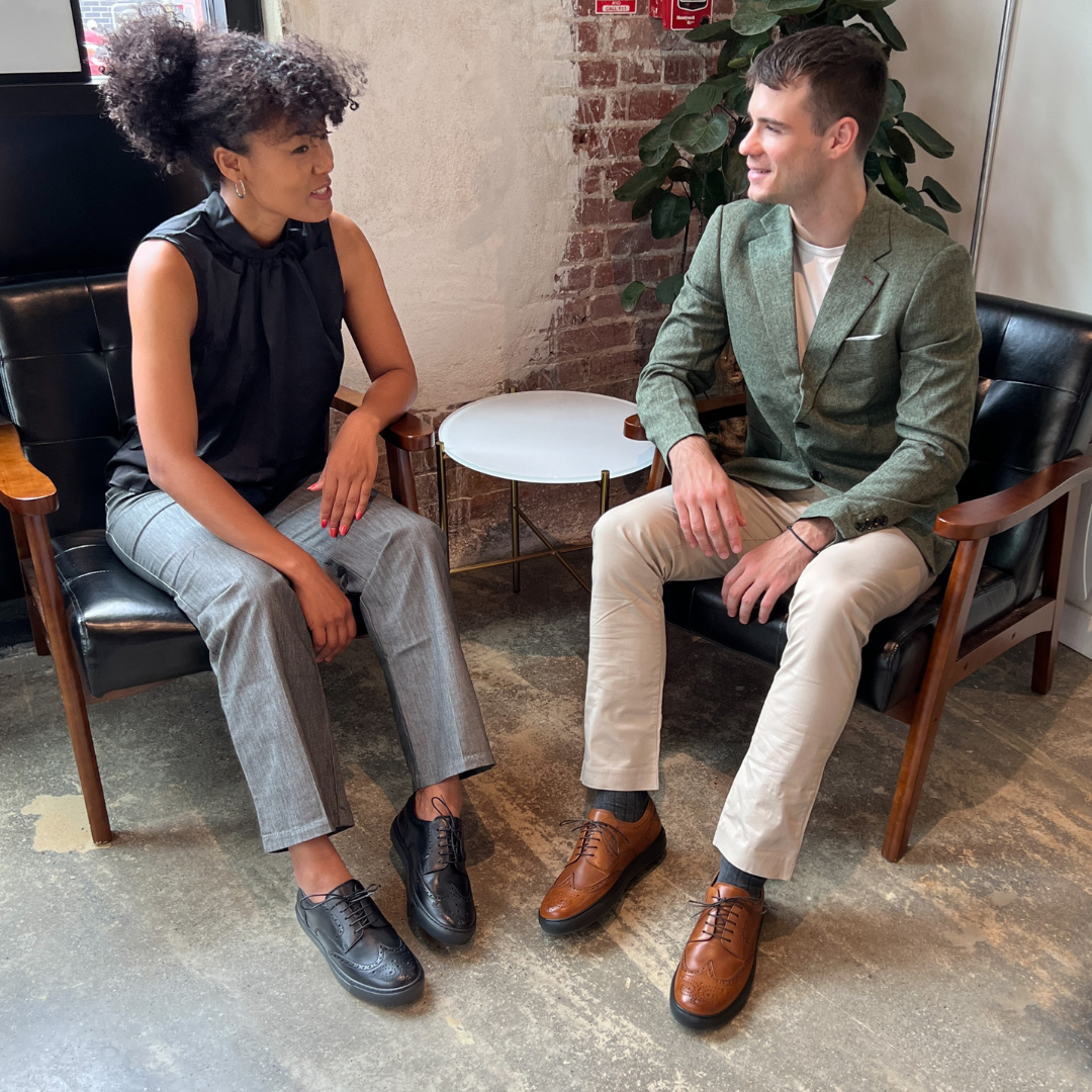 Cognac wingtip oxford shoes worn with light pants