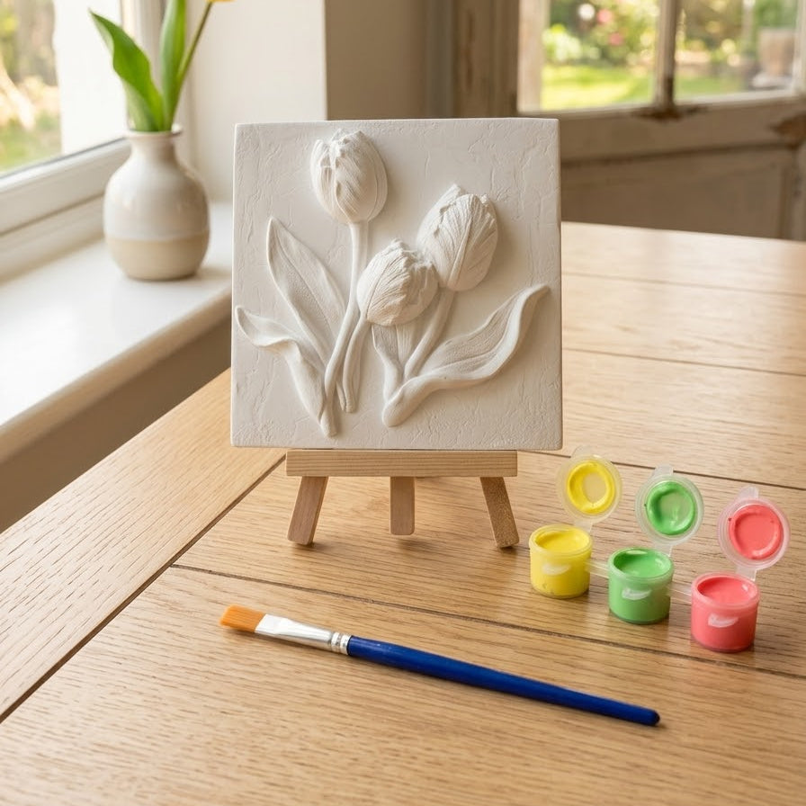 White tulip relief plaque on mini easel with paint pots and brush