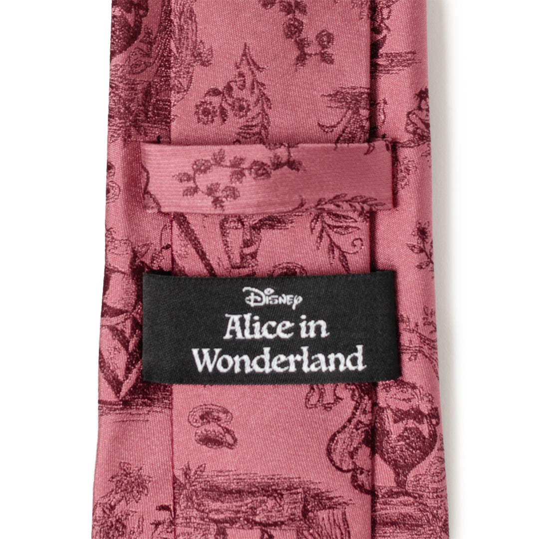 Dusty red necktie with black label reading Alice in Wonderland