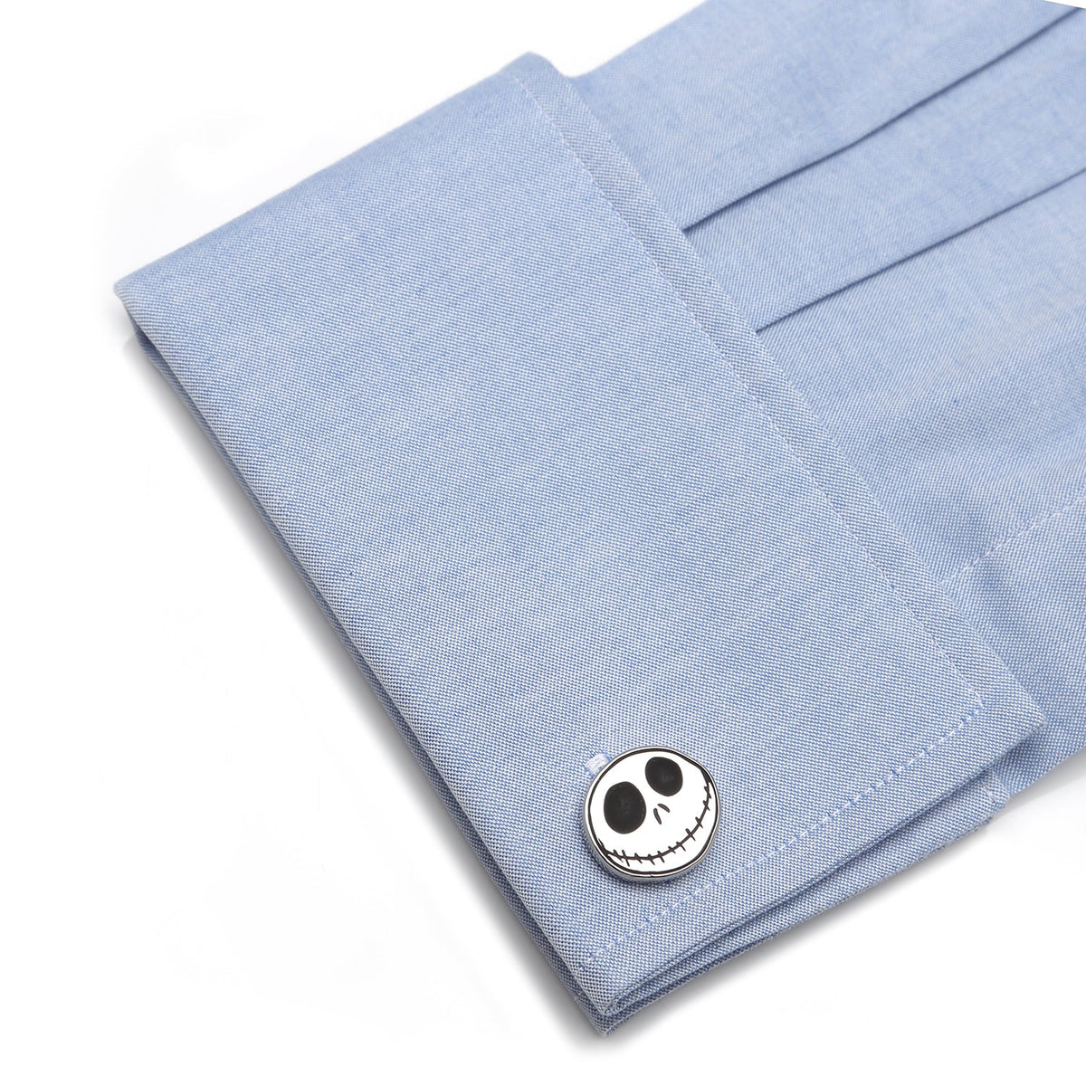 Jack Skellington skull cufflink fastened on a light blue shirt cuff