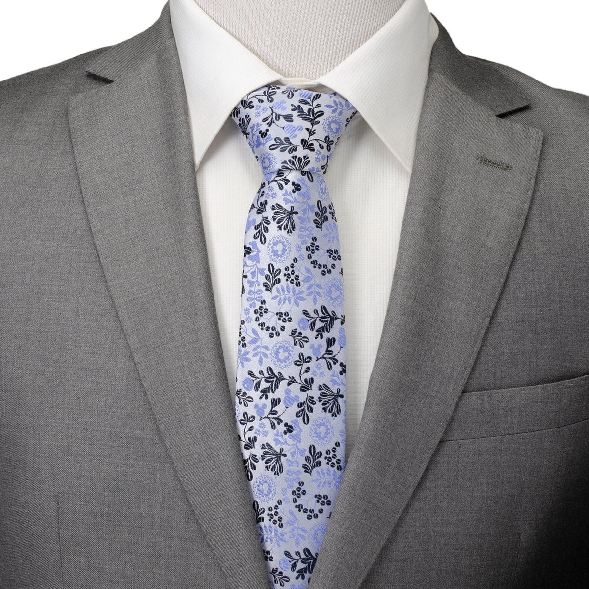 Light blue floral necktie on white shirt, worn with gray blazer