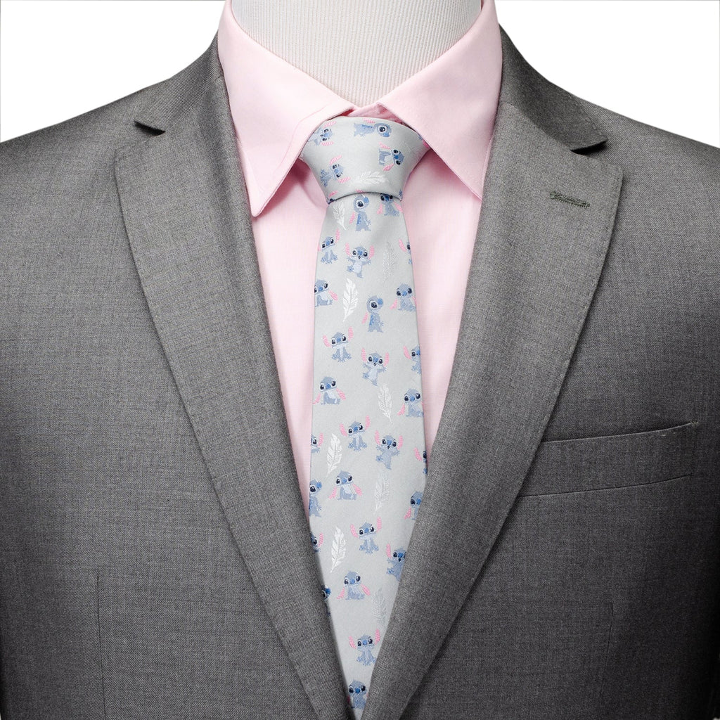 Patterned tie worn with pink dress shirt and gray suit jacket
