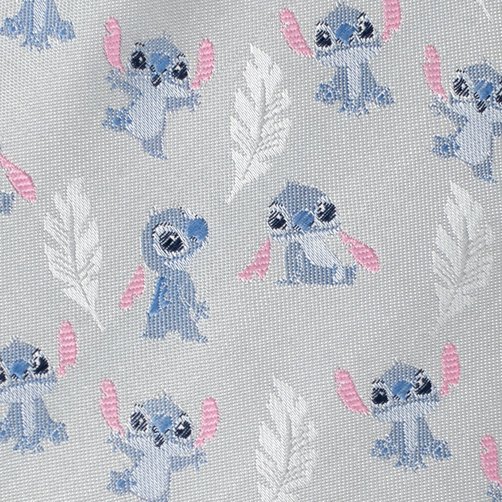 Close-up of light gray tie fabric with blue Stitch print and pink accents