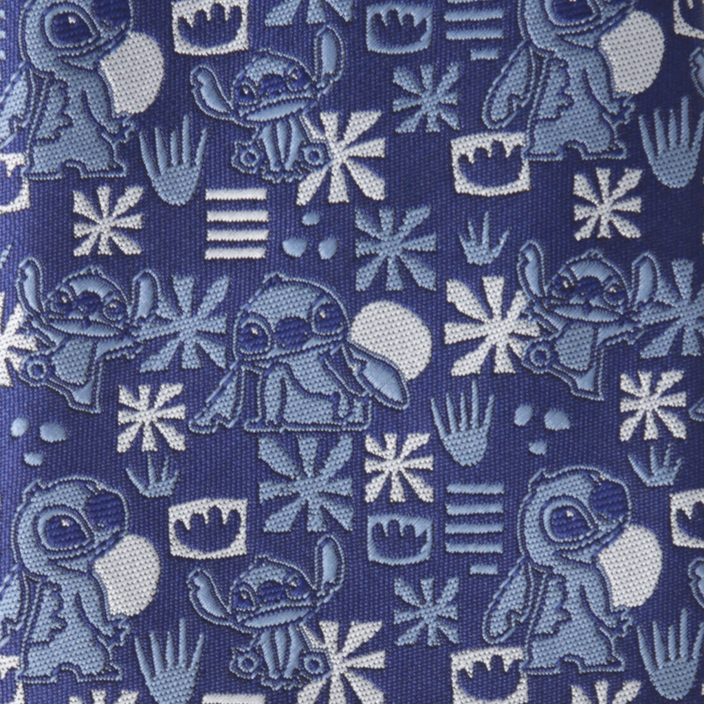 Close-up of blue tie fabric with Stitch faces, snowflakes, and crowns