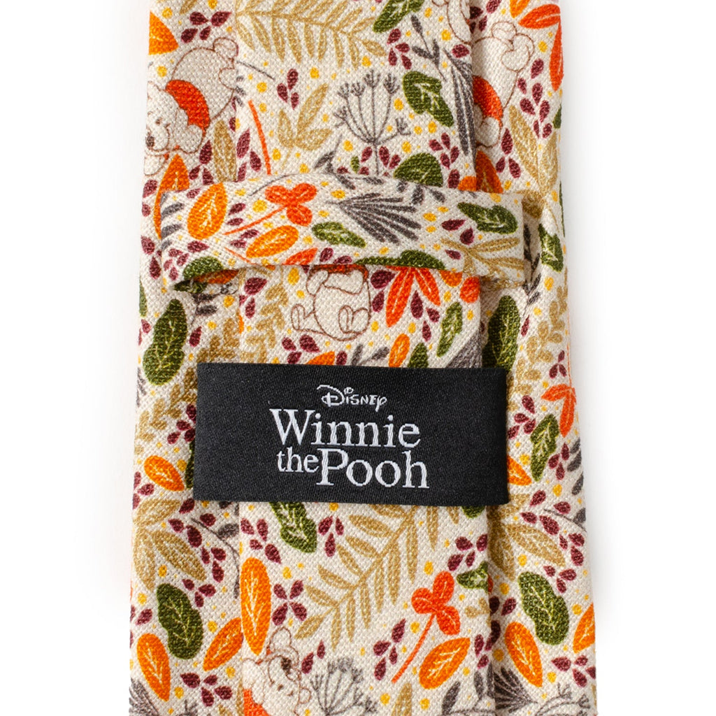 Men's necktie with Winnie the Pooh label; tan fabric with orange and green motifs