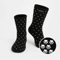 Black fleece socks with white polka dots; cuff logo and skull print