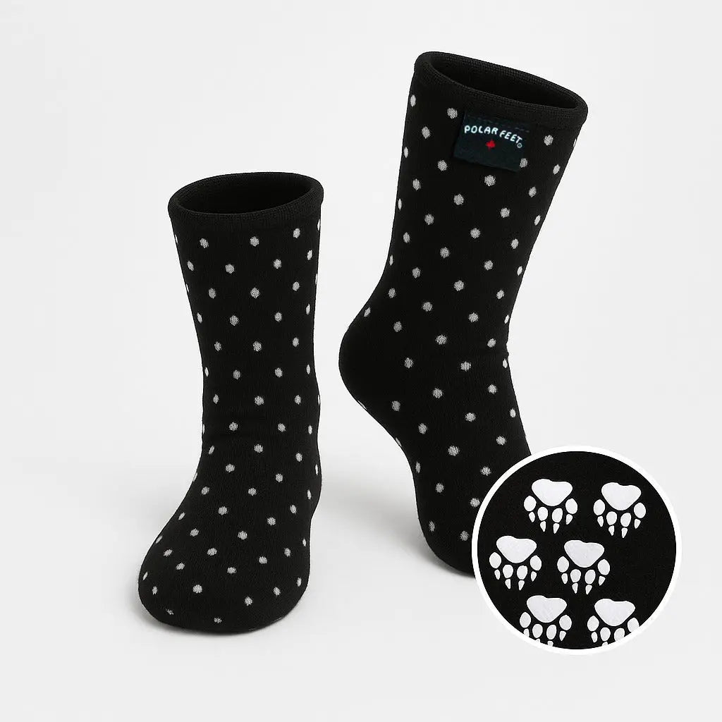 Black fleece socks with white polka dots; cuff logo and skull print