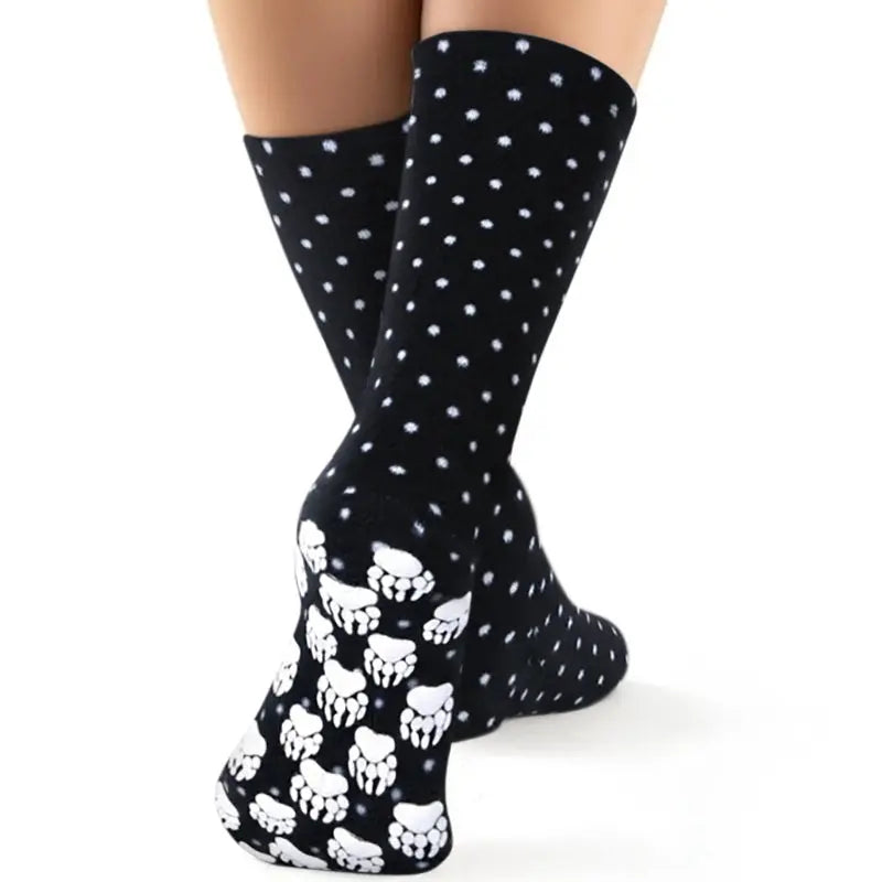 Black fleece socks with white pawprint pattern near the foot