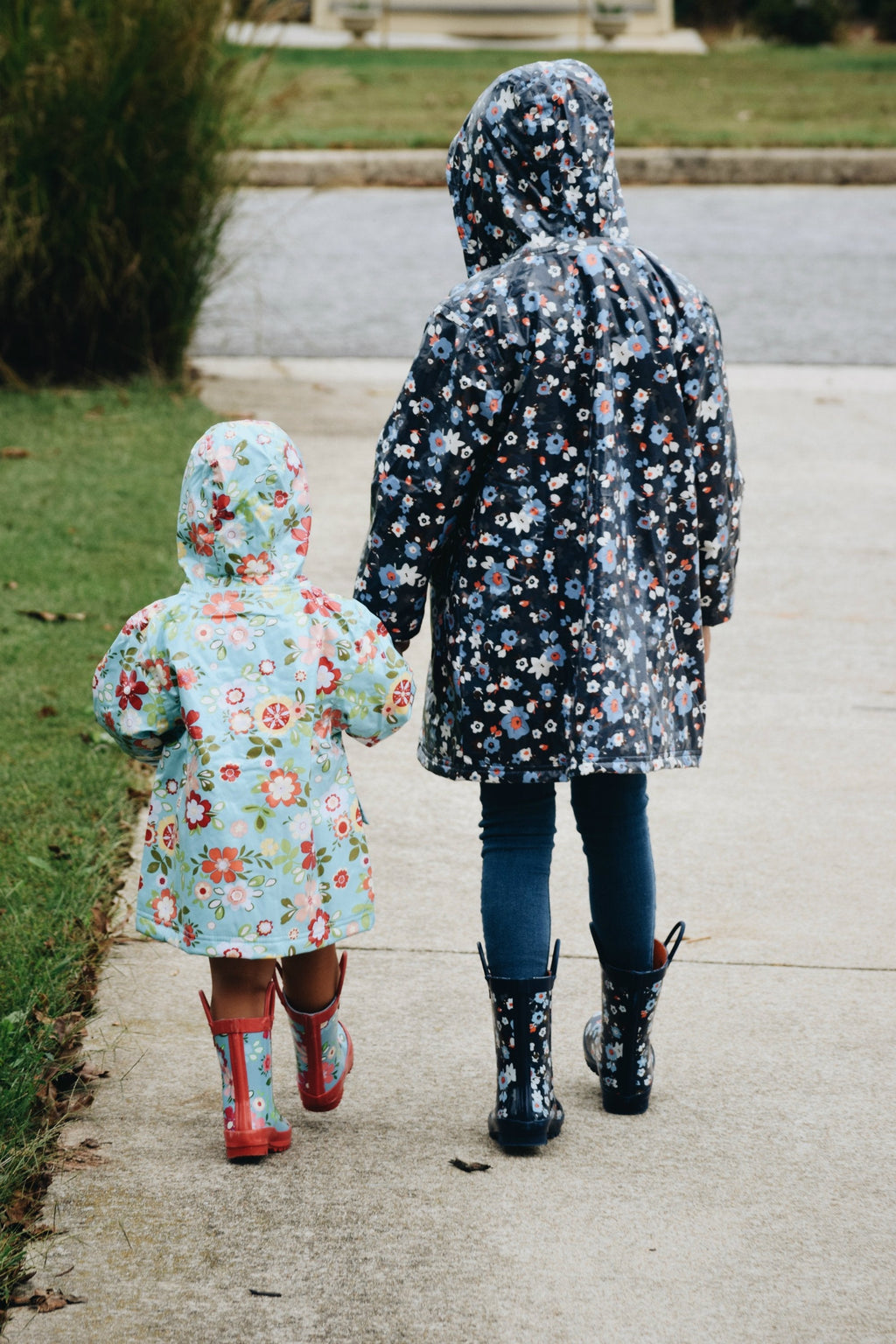 Floral light blue hooded raincoat, back view with full-length zipper and roomy hood