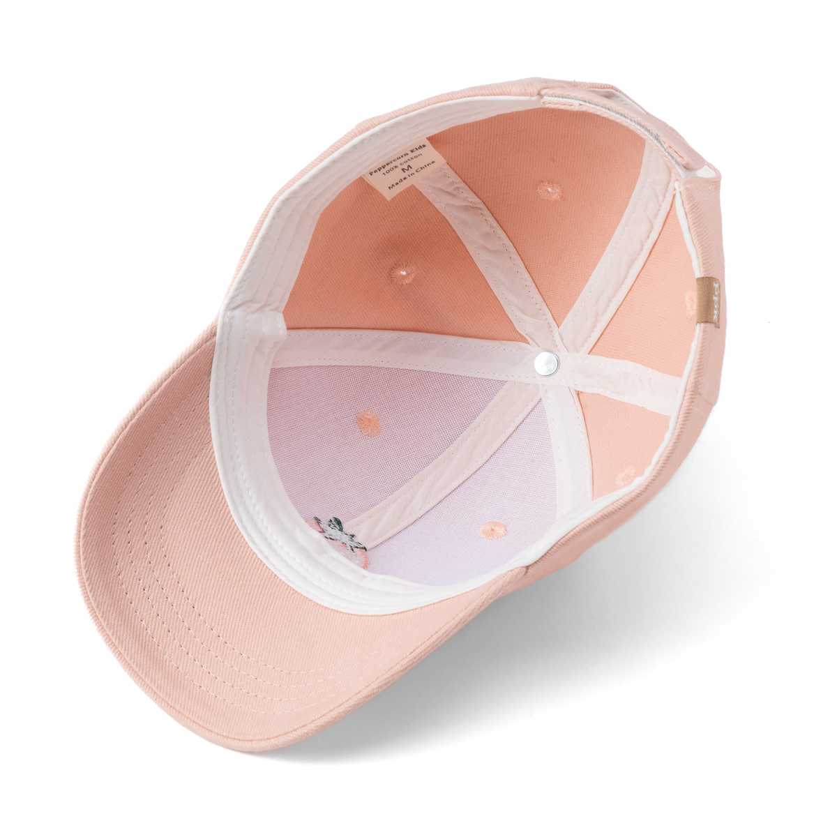 Pastel pink baseball cap interior with white mesh lining and button detail