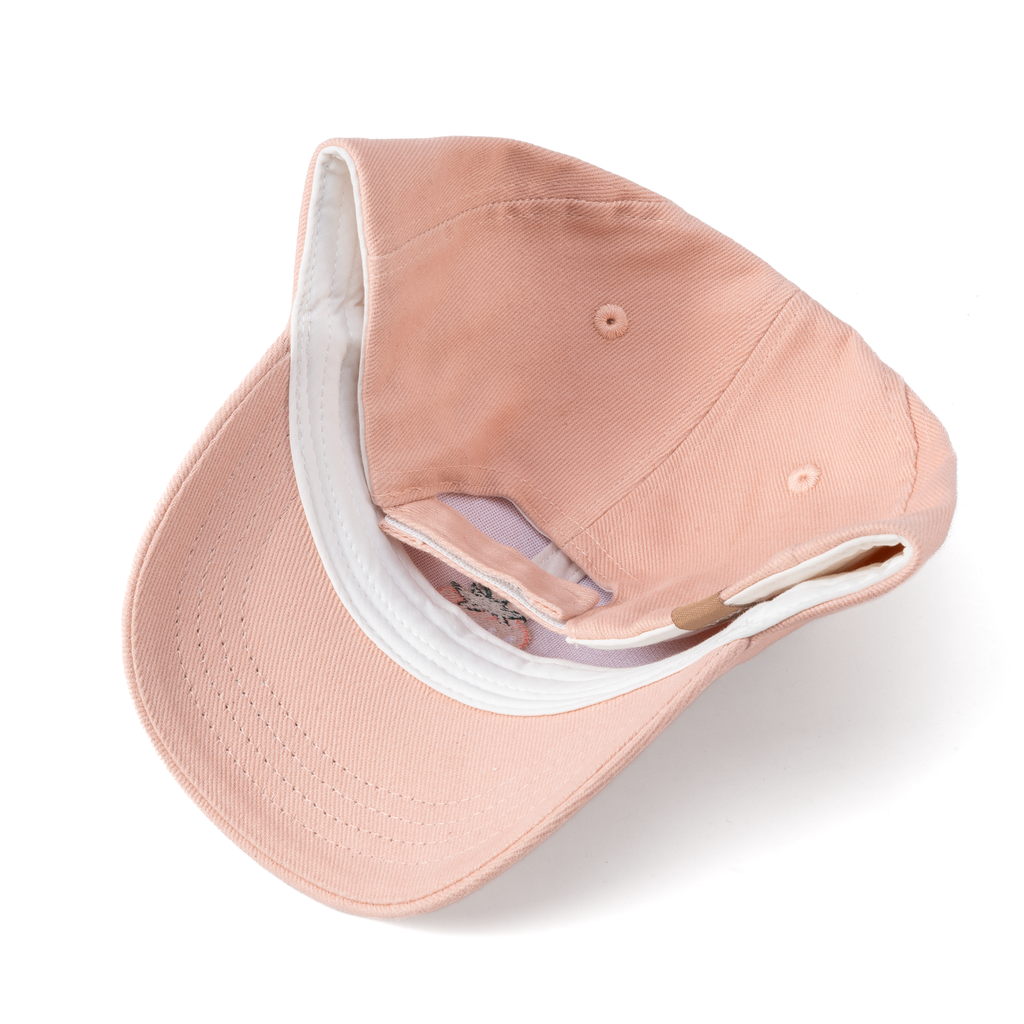 Pastel pink baseball cap with white inner band and adjustable back strap
