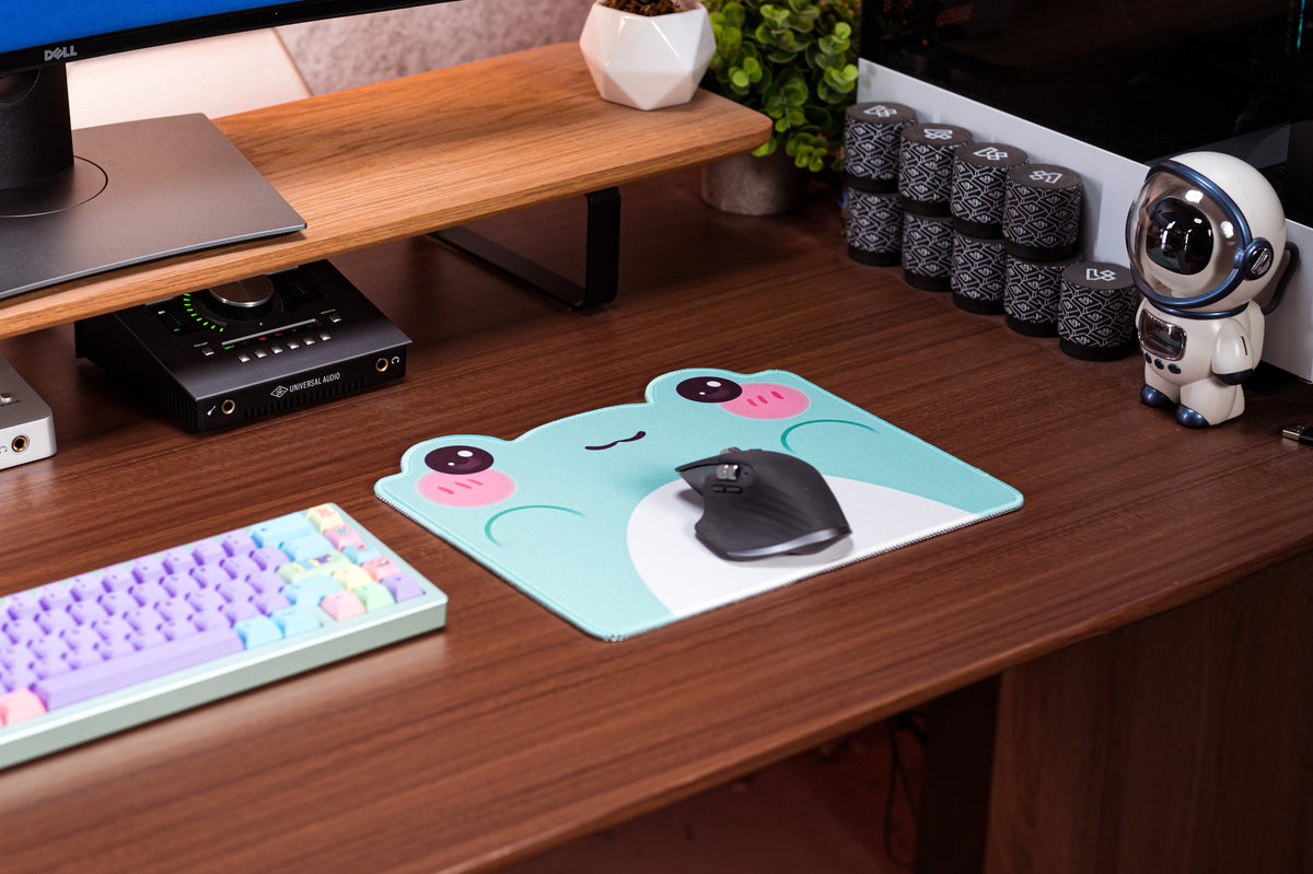 Teal frog-themed desk mat with white belly graphic and pink cheek dots