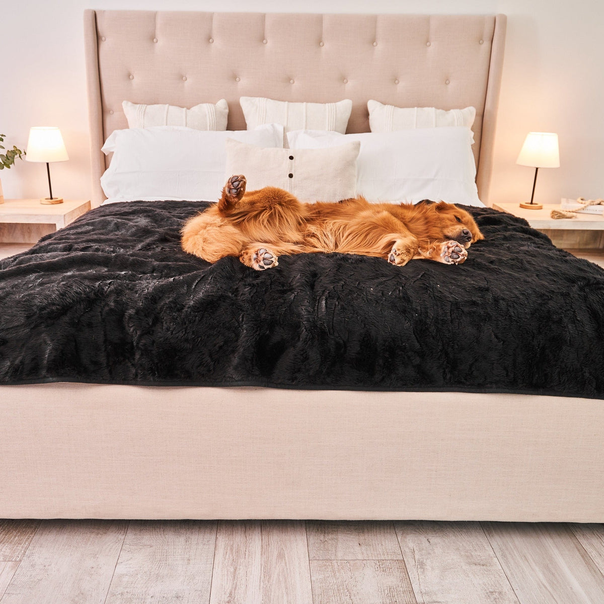 Midnight black waterproof faux fur throw blanket with raised pile, on a bed