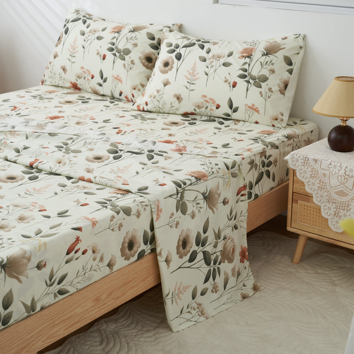 Floral microfiber sheet set featuring cream fabric with garden leaves and flowers; layered bed cover