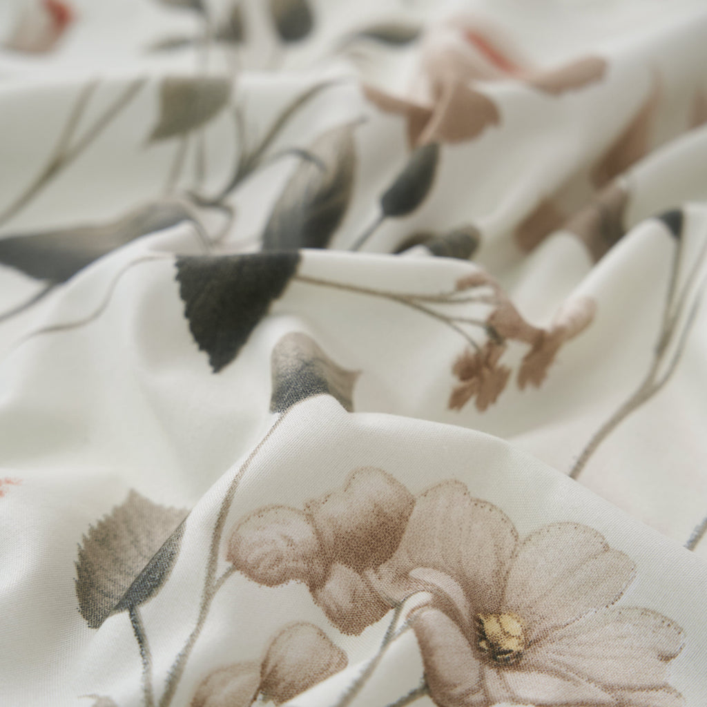 Soft floral microfiber fabric close-up in cream with muted botanical print and small flowers