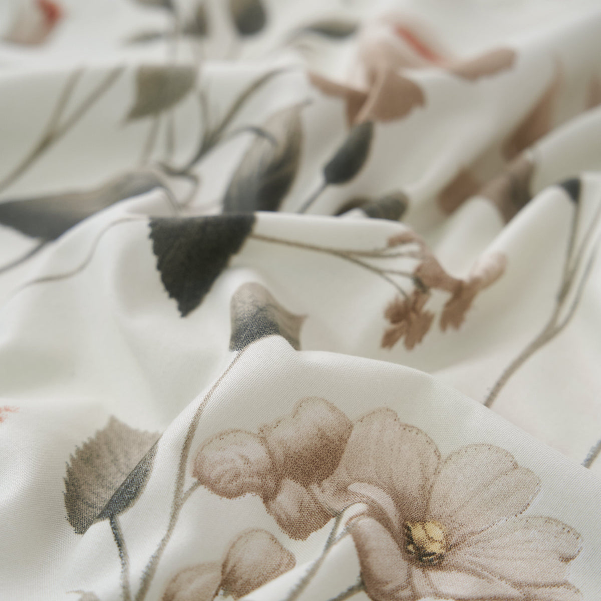 Soft floral microfiber fabric close-up in cream with muted botanical print and small flowers