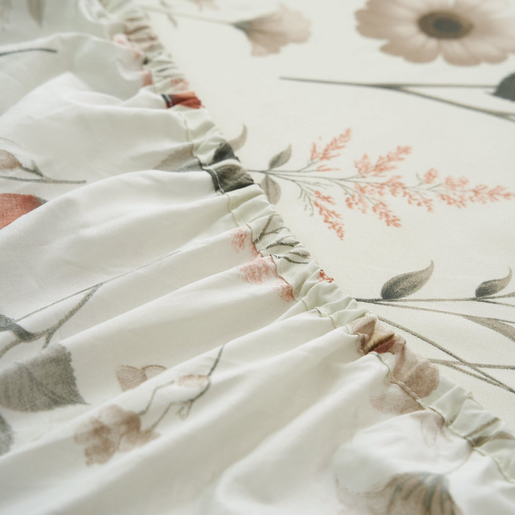 Microfiber sheet fabric close-up with botanical floral print and visible seam detail