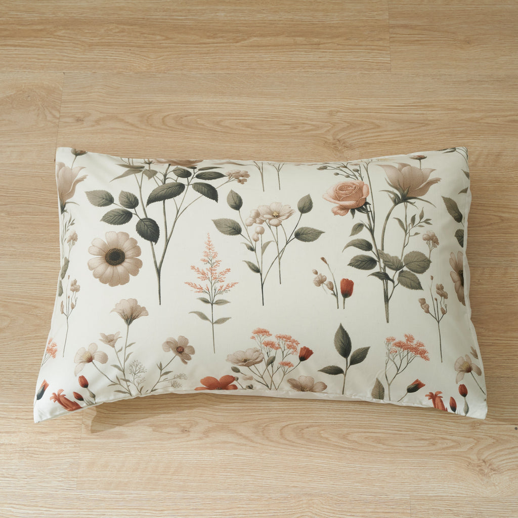 Pair of floral pillowcases in cream with meadow flowers and leaves print