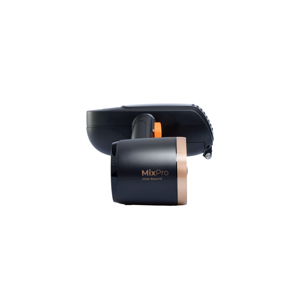 Compact grooming device in dark color with open front head and orange button