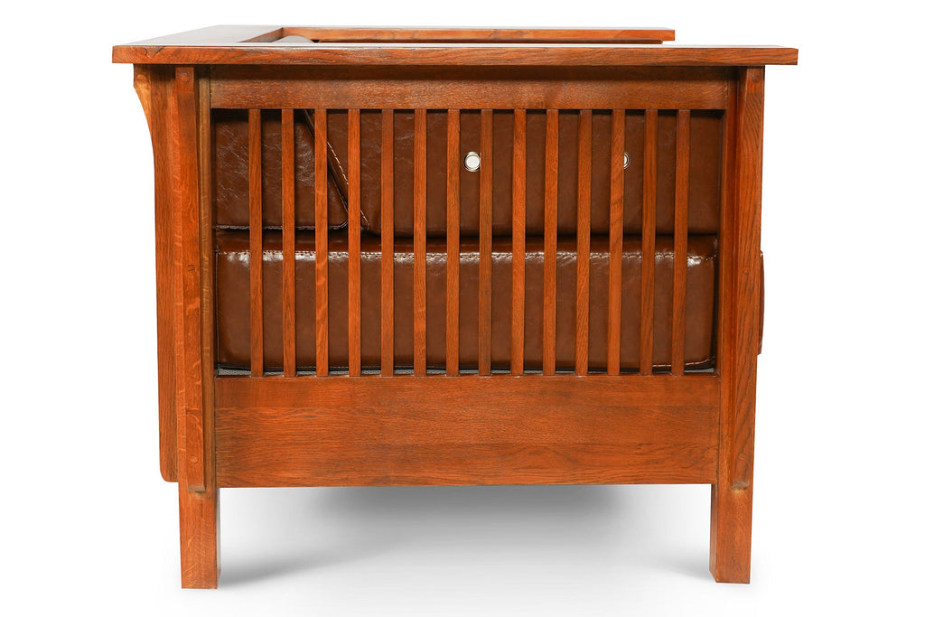 Brown leather side arm chair with slatted front panel and open lower grille.