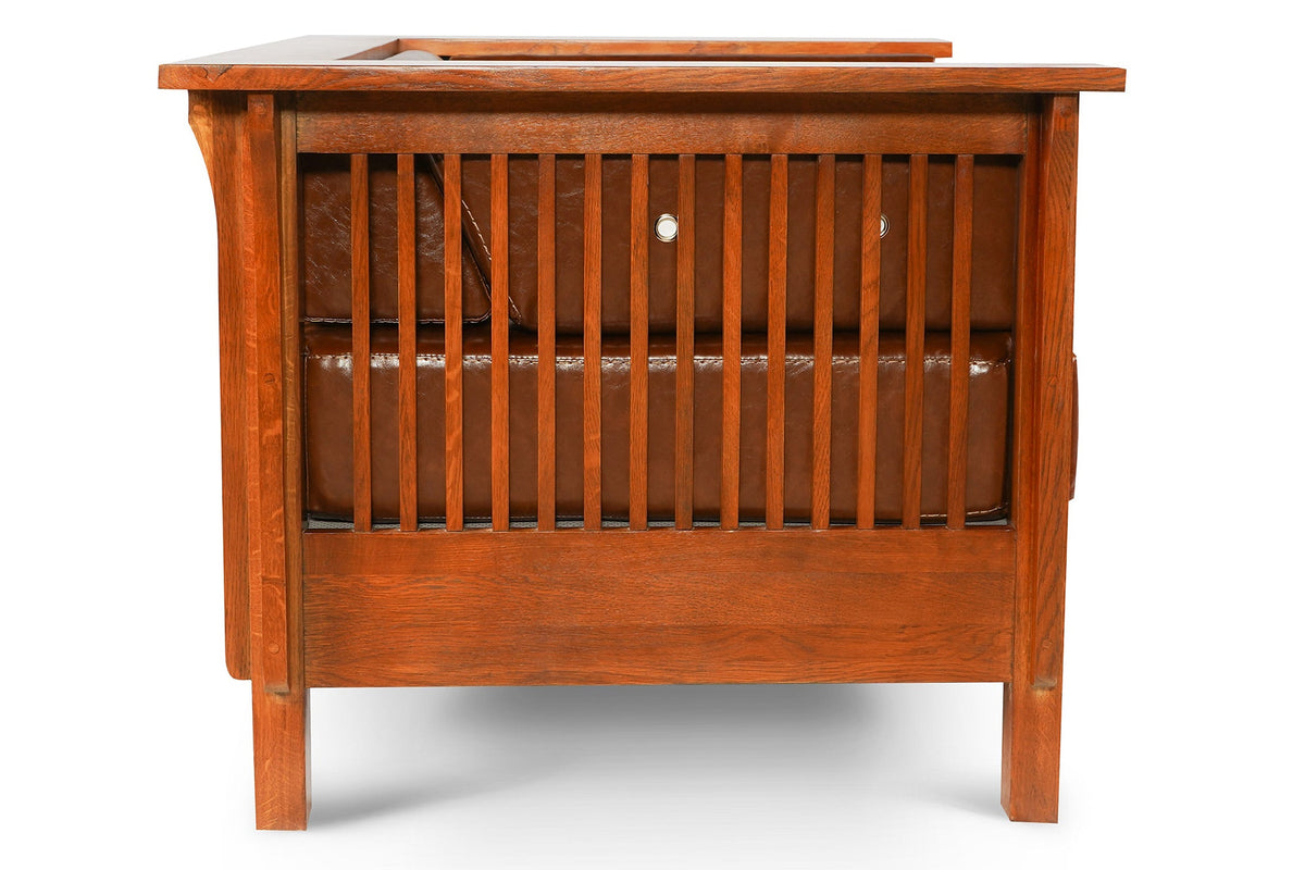 Brown leather side arm chair with slatted front panel and open lower grille.