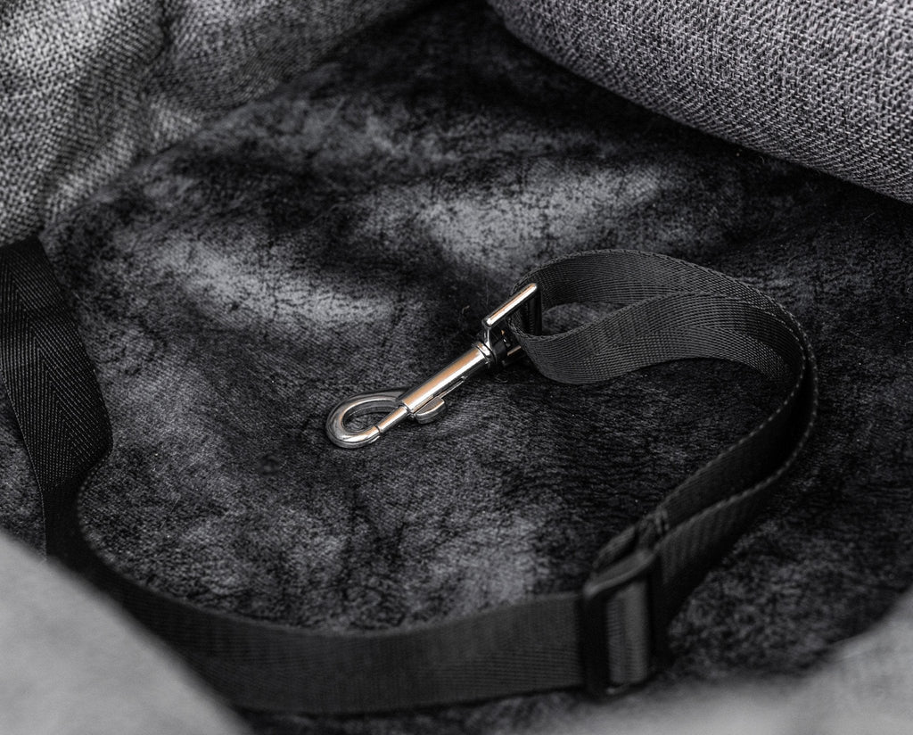Dog car bed with gray fabric and secure seatbelt strap with metal clip