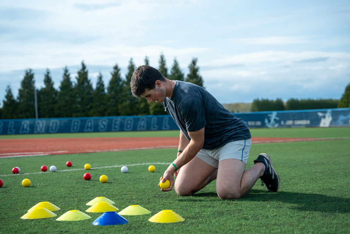 Player holding a SMUSH BALLS stress ball during outdoor training.