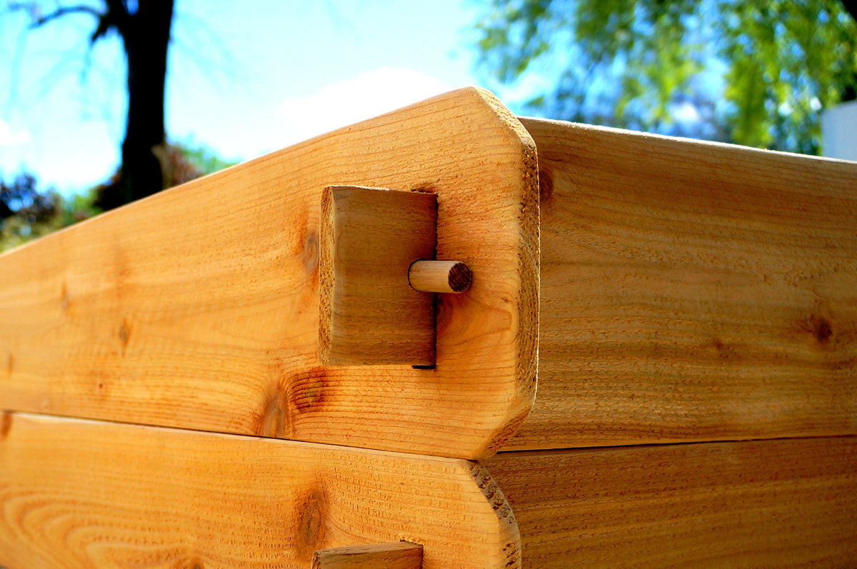 Cedar raised garden bed corner join with interlocking wood pegs and bracket blocks