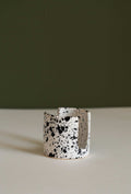 Ceramic sponge holder cup with speckled black-and-white splatter pattern