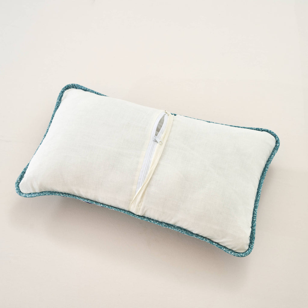 Turquoise-edged lumbar pillow sham with white backing and hidden zipper closure