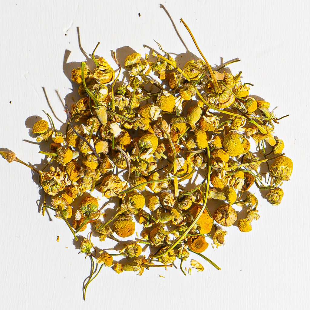 Organic chamomile herbal tea dried flower blend in a loose pile