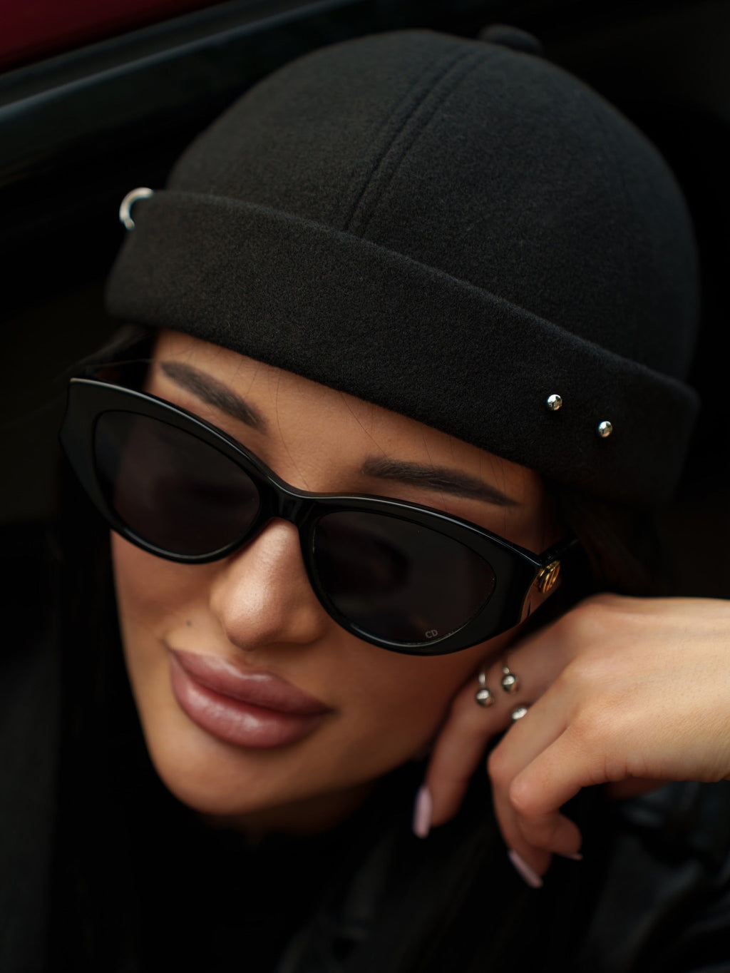Black pierced docker cap close-up with metal studs on the side band