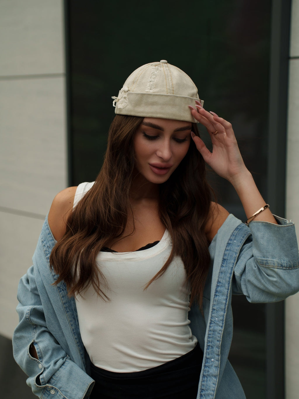 Beige canvas Docker-style cap with curved brim and stitched crown seams