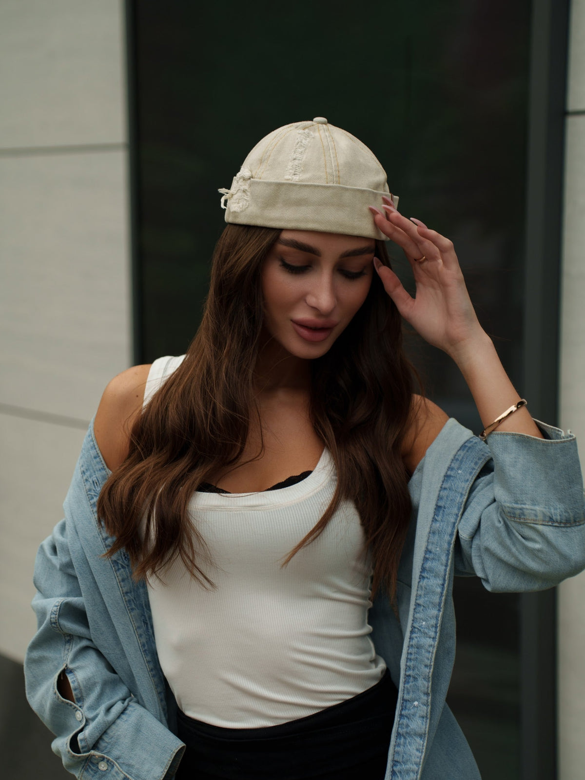 Beige canvas Docker-style cap with curved brim and stitched crown seams