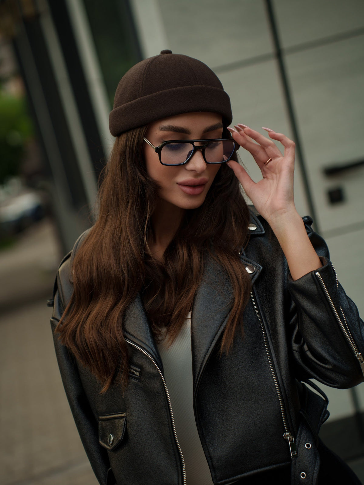Chocolate-brown Docker cap on model, snug fit with folded cuff brim