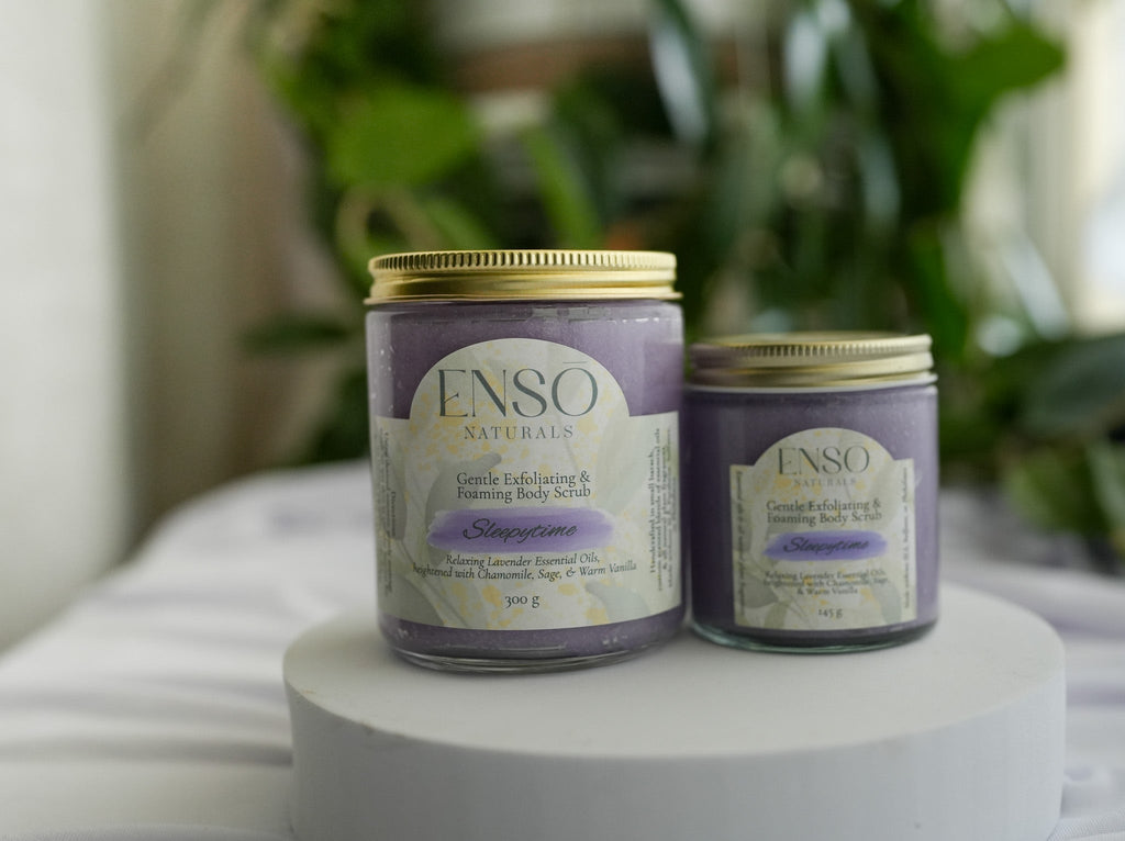 Gentle foaming sugar scrub jars with gold lids, lavender and pale tubs on stand