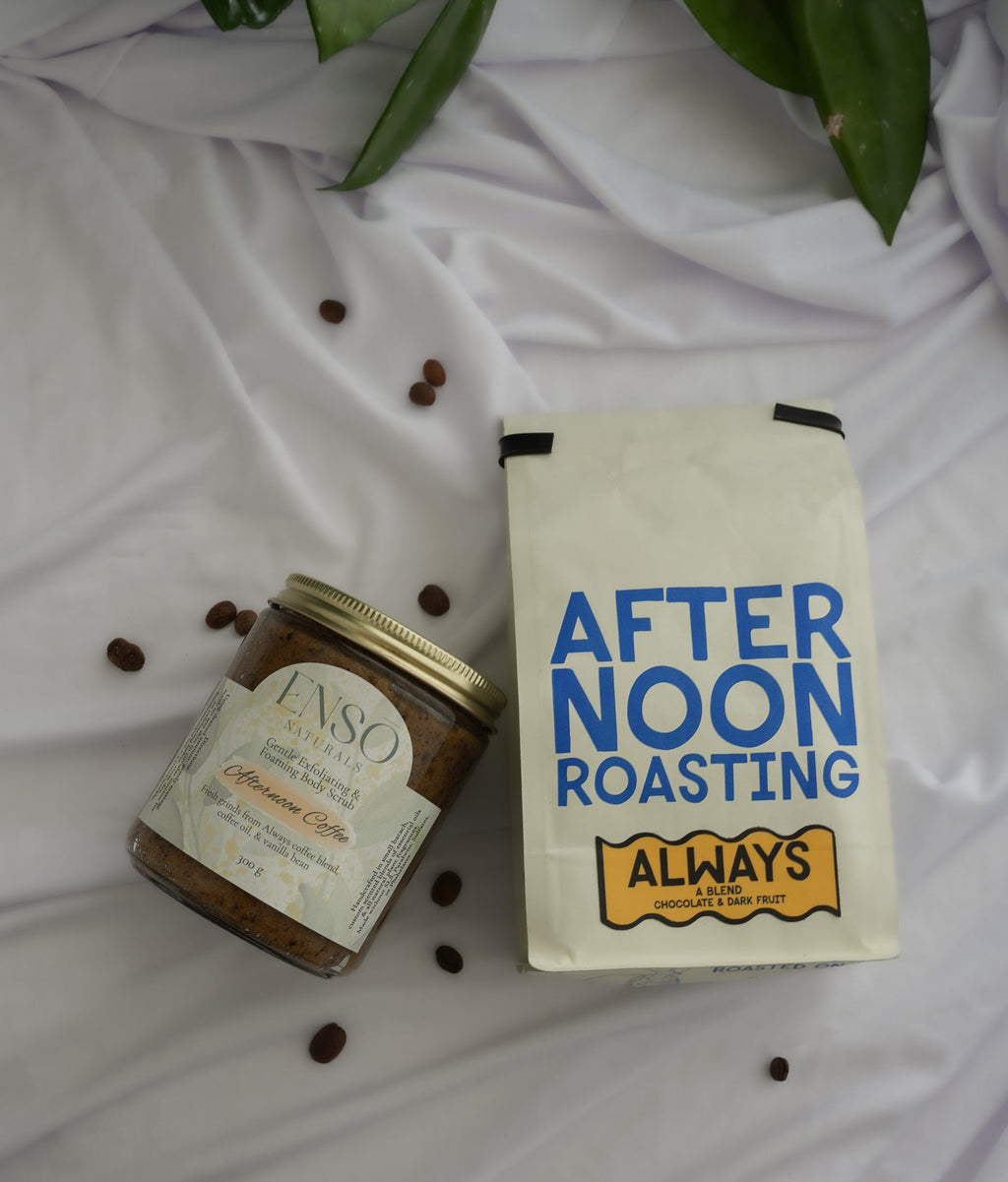 Gentle foaming sugar scrub jar lying beside After Noon Roasting pouch with coffee beans