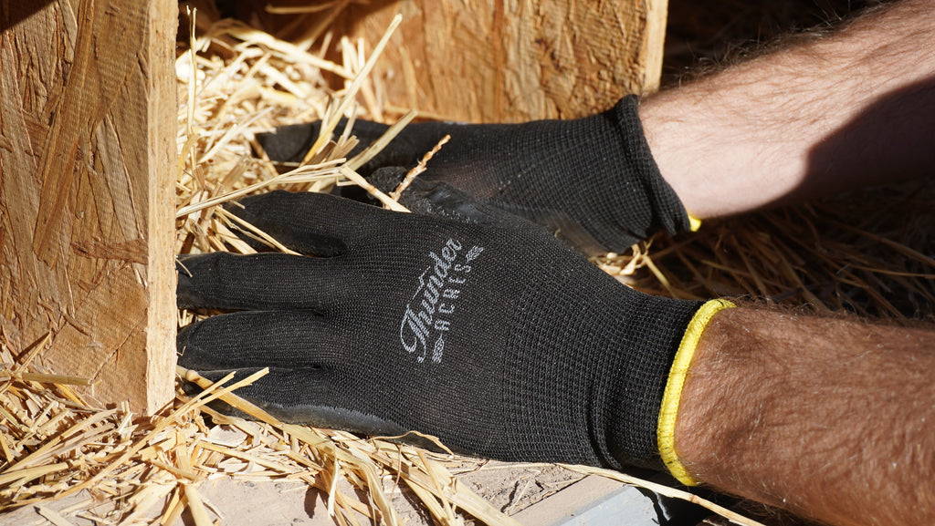 Black nitrile-coated garden gloves with yellow cuff, worn on hand