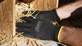 Black nitrile-coated garden gloves with yellow cuff, worn on hand