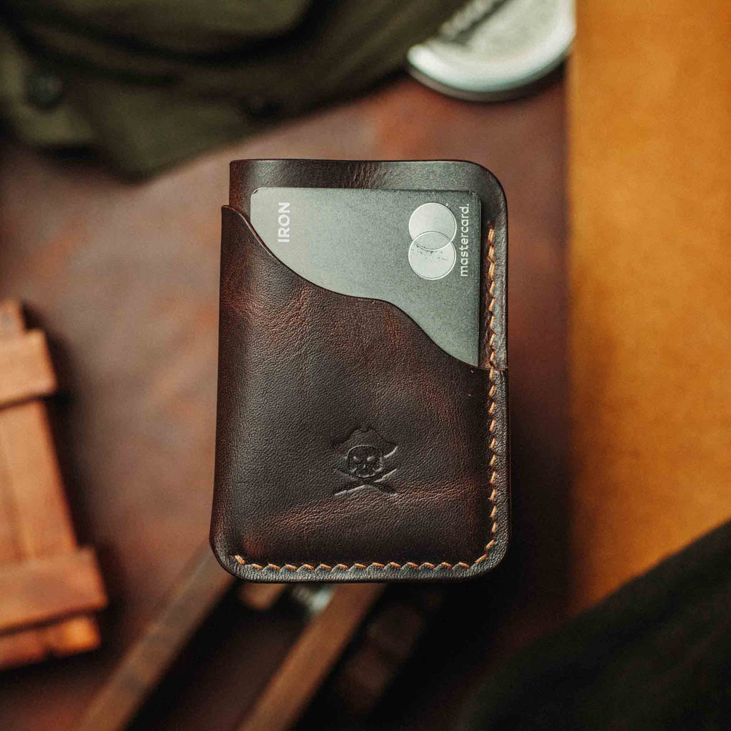 Black minimalist leather wallet with embossed logo and contrast edge stitching
