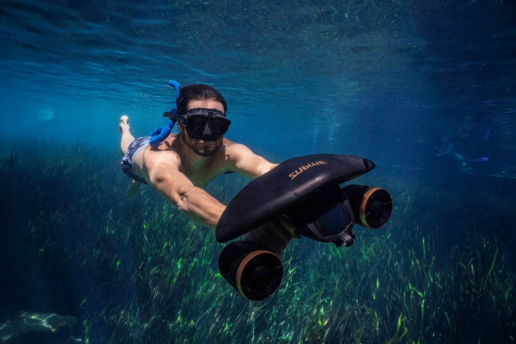 Underwater camera pod with two front lenses, used underwater by masked diver
